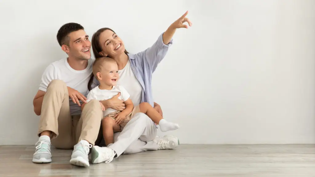 How Life Insurance Protects Your Family's Future in Uncertain Times 4 happy young family with infant baby sitting on flo 2021 10 11 16 28 49 utc scaled 1024x576 1
